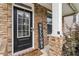 Close-up of a front door with a welcome sign and decorative plants creating curb appeal at 1469 Cliff View Ter, Conyers, GA 30012