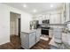 Bright kitchen with stainless steel appliances, island, and white cabinets at 1469 Cliff View Ter, Conyers, GA 30012