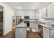 Well-lit kitchen features stainless steel appliances, granite countertops, and dark wood flooring at 1469 Cliff View Ter, Conyers, GA 30012