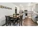 Open-concept kitchen with stainless steel appliances, granite countertops, and a dining area at 1469 Cliff View Ter, Conyers, GA 30012