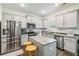 Modern kitchen with stainless steel appliances, granite countertops, and a center island at 1469 Cliff View Ter, Conyers, GA 30012