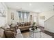 Cozy living room showcasing hardwood floors, a comfortable sofa, and ample natural light at 1469 Cliff View Ter, Conyers, GA 30012