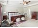 Well-lit main bedroom with ceiling fan, ensuite bathroom, and neutral decor at 1469 Cliff View Ter, Conyers, GA 30012