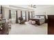 Spacious primary bedroom with sitting area, ceiling fan and large windows at 1469 Cliff View Ter, Conyers, GA 30012