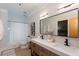 Bright bathroom featuring double sinks, a large mirror, tile floors, and a shower with a tub at 15 Waddell Ne St # 101, Atlanta, GA 30307