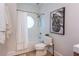 Bathroom features a tiled shower and tub with a unique circular window and modern fixtures at 15 Waddell Ne St # 101, Atlanta, GA 30307