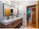 Bathroom with double sinks, quartz counters, wood cabinets, and modern fixtures at 15 Waddell Ne St # 101, Atlanta, GA 30307