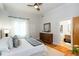 Bright bedroom boasts hardwood floors, ceiling fan, and an ensuite bathroom through the doorway at 15 Waddell Ne St # 101, Atlanta, GA 30307