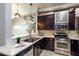 Modern kitchen with stainless steel appliances, dark cabinetry, and stylish pendant lighting at 15 Waddell Ne St # 101, Atlanta, GA 30307
