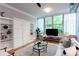 Bright living room featuring a Murphy bed and hardwood floors at 15 Waddell Ne St # 101, Atlanta, GA 30307