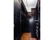 A dark wood walk-in closet features custom shelving and organization, with hardwood flooring at 15 Waddell Ne St # 101, Atlanta, GA 30307