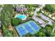An aerial view of community amenities showcasing tennis courts, swimming pool, clubhouse and a lush landscape at 6403 Queens Court Trce, Mableton, GA 30126