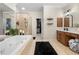 Spacious bathroom with a soaking tub, glass shower, and a walk-in closet at 6403 Queens Court Trce, Mableton, GA 30126