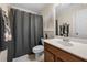 Well-lit bathroom with a shower curtain, modern sink, and neutral decor at 6403 Queens Court Trce, Mableton, GA 30126