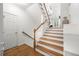 Inviting entryway with wood floors and stairs leading to the main level with natural light at 6403 Queens Court Trce, Mableton, GA 30126