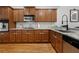 Well-appointed kitchen featuring granite countertops, modern appliances, warm wood cabinets, and a stylish backsplash at 6403 Queens Court Trce, Mableton, GA 30126
