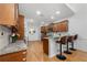 Open kitchen featuring warm wood cabinets, granite countertops, stainless appliances, and barstool seating at 6403 Queens Court Trce, Mableton, GA 30126