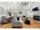 Cozy living room with fireplace, hardwood floors, and large windows overlooking the backyard at 6403 Queens Court Trce, Mableton, GA 30126