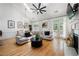 Bright living room with vaulted ceilings, fireplace, hardwood floors, and oversized windows at 6403 Queens Court Trce, Mableton, GA 30126