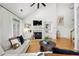 Inviting living room featuring hardwood floors, a fireplace, and built-in shelving at 6403 Queens Court Trce, Mableton, GA 30126