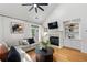 Bright living room featuring a fireplace with built-ins and hardwood flooring at 6403 Queens Court Trce, Mableton, GA 30126