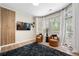 Cozy living room featuring modern decor, hardwood floors, and a beautiful view through large windows at 6403 Queens Court Trce, Mableton, GA 30126