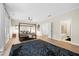 The main bedroom features a large rug, hardwood floors, and access to the ensuite bathroom at 6403 Queens Court Trce, Mableton, GA 30126