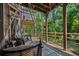 Cozy porch area with comfortable seating, great shade, and a tranquil view of the backyard at 6403 Queens Court Trce, Mableton, GA 30126