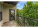 Balcony view featuring a wood deck, black metal railing and a scenic view of lush trees at 898 Oak Sw St # 1301, Atlanta, GA 30310