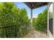 Balcony with wood deck and black metal railing overlooking lush green trees at 898 Oak Sw St # 1301, Atlanta, GA 30310