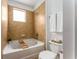 Cozy bathroom features a soaking tub with tile surround and a toilet with convenient towel storage at 898 Oak Sw St # 1301, Atlanta, GA 30310