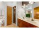Bathroom with a double sink vanity, glass-enclosed shower, and neutral tile flooring at 898 Oak Sw St # 1301, Atlanta, GA 30310