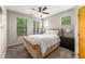 Bright bedroom with a large bed, ceiling fan, and several windows providing natural light at 898 Oak Sw St # 1301, Atlanta, GA 30310
