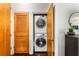 Laundry room with stacked washer and dryer, accessible from the hallway, and next to storage at 898 Oak Sw St # 1301, Atlanta, GA 30310