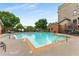 Enjoy the community pool with a light blue water and concrete pool deck with lounge seating and landscaping at 898 Oak Sw St # 1301, Atlanta, GA 30310