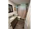 Cozy bathroom with granite vanity and shower with pink curtain at 241 Wooten Ct, Canton, GA 30114