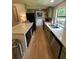Well-lit kitchen features green cabinets, light countertops, modern appliances, and an island at 241 Wooten Ct, Canton, GA 30114