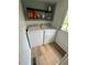 Well-equipped laundry room with a washing machine and dryer and a storage shelf above at 241 Wooten Ct, Canton, GA 30114