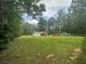 Expansive yard with lush greenery and a charming home nestled among mature trees at 241 Wooten Ct, Canton, GA 30114