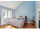 Bright bedroom featuring hardwood floors, a comfortable bed, and a window with natural light at 3268 Clairmont North Ne Rd, Brookhaven, GA 30329