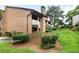 Brick townhome with a balcony and lush landscaping at 3268 Clairmont North Ne Rd, Brookhaven, GA 30329