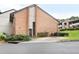 This exterior showcases a two-story brick home, complemented by a paved driveway and lush, green landscaping at 3268 Clairmont North Ne Rd, Brookhaven, GA 30329