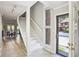 Bright foyer featuring a staircase, tile flooring, with view into the dining area and a glimpse of the outdoors at 3268 Clairmont North Ne Rd, Brookhaven, GA 30329