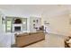 Bright living room with a fireplace and dining area, complemented by neutral walls, floors and a sectional sofa at 3268 Clairmont North Ne Rd, Brookhaven, GA 30329