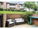 Private patio is surrounded by brick walls, green grass, and outdoor seating at 3268 Clairmont North Ne Rd, Brookhaven, GA 30329
