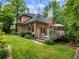 Well-maintained backyard with a spacious deck, lush lawn, and mature trees, perfect for outdoor entertaining at 350 Fountain Oaks Ln, Atlanta, GA 30342