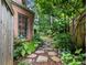 Secluded backyard garden featuring a stone pathway, lush greenery, and a serene, private setting at 350 Fountain Oaks Ln, Atlanta, GA 30342