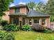 Lush backyard featuring mature trees, well-maintained lawn, and large windows providing ample natural light at 350 Fountain Oaks Ln, Atlanta, GA 30342