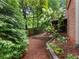 The backyard is landscaped with trees and flowering shrubs leading to a deck at 350 Fountain Oaks Ln, Atlanta, GA 30342