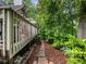 A stone path leads from the deck through the landscaped backyard at 350 Fountain Oaks Ln, Atlanta, GA 30342